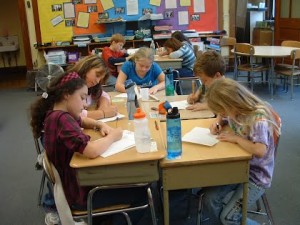 Students work on their immigration letters at Maple Elementary School