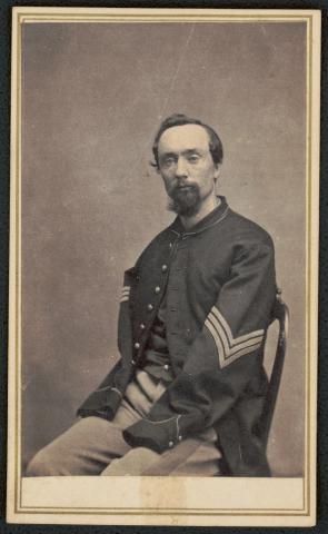 Sergeant Thomas Plunkett of Company E, 21st Massachusetts Infantry Regiment, bearded young man in Union uniform seated with amputated arms.