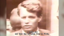 Screen shot of Senator Robert F. Kennedy with words on screen: '...a snake pit that the students live in filth...'