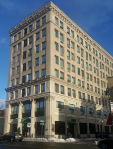 photo of 8-story hotel against a blue sky