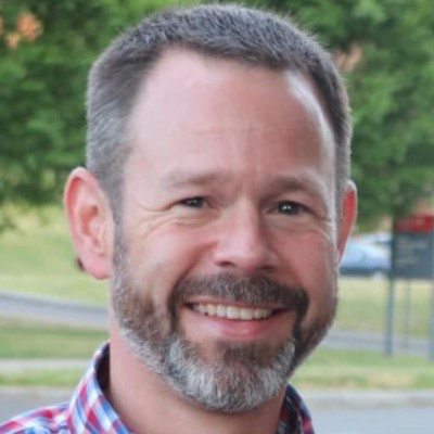 Head shot photo of Peter Vamosy, a white man with a graying beard and short hair.