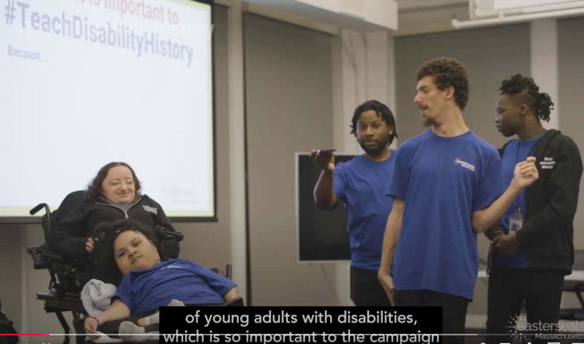 Desi Forte a woman in a wheelchair and a diverse group of young adults wearing Easterseals Massachusetts T-shirt present  